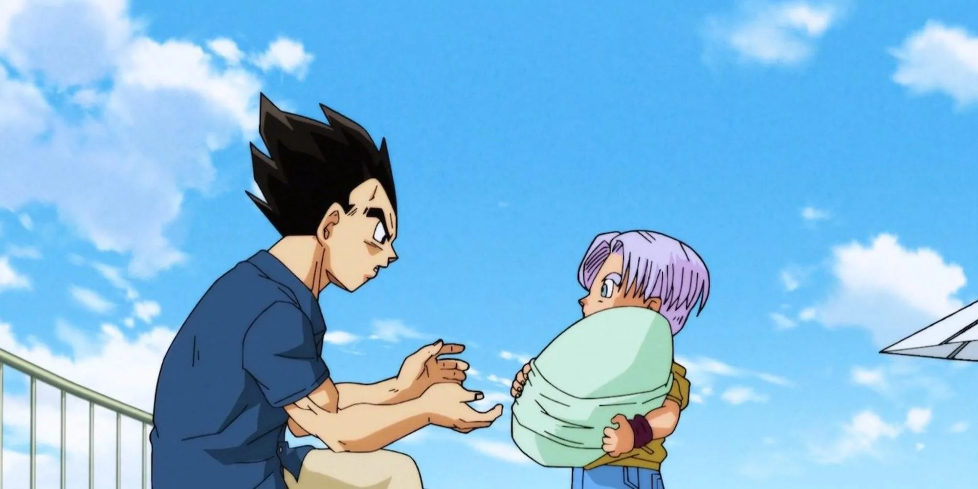 Vegeta bế con gái mới sinh Bulla trong khi Trunks đứng cạnh, thể hiện khoảnh khắc gia đình ấm áp