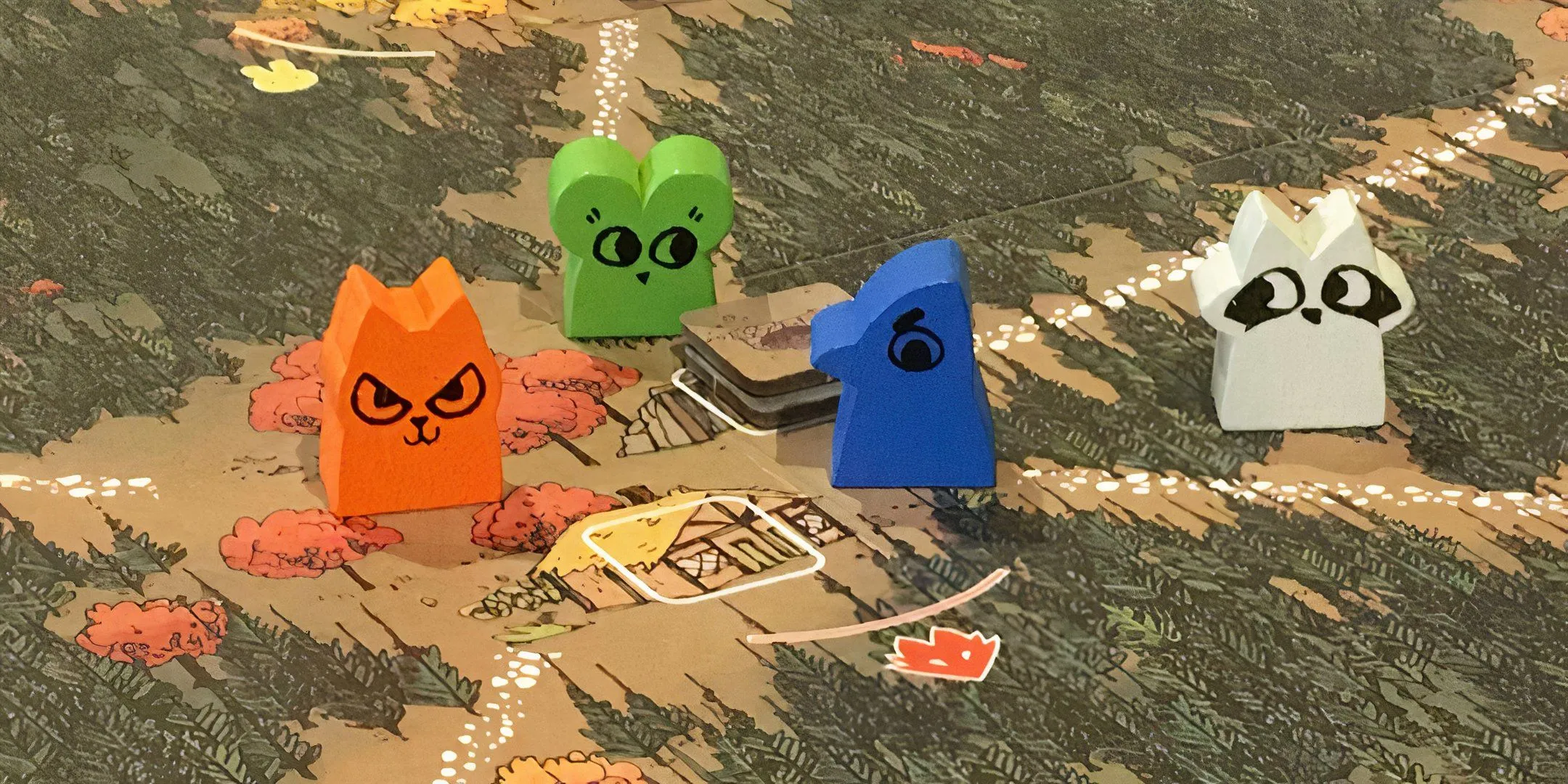 Bốn quân cờ meeples đáng yêu đại diện các phe phái tranh giành lãnh thổ trong game Root.